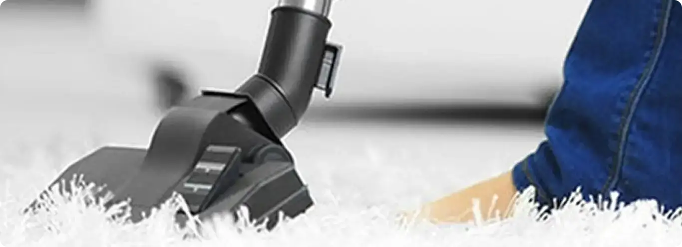 Close-up of a professional vacuuming a white carpet in Mercer Island.